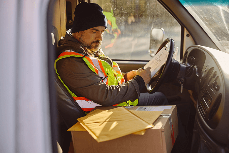 truck-driver-going-through-shipment-list-while-che-2024-12-13-19-14-17-utc